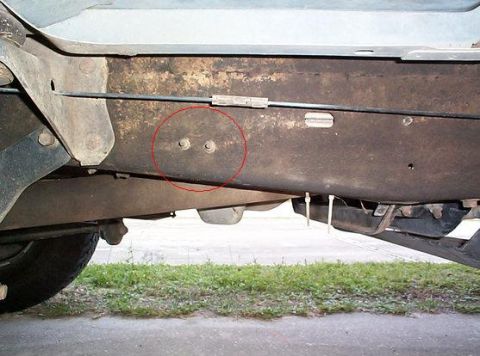 1992 Ford Bronco - Once the fender mount has been relocated on the driver's side, you have to unbolt these two nuts that go through the frame to a fuel hose b…