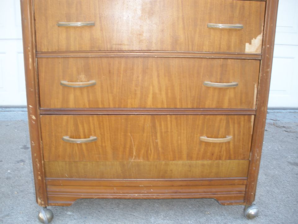 Vintage blonde waterfall wood dresser with brass pulls on a driveway