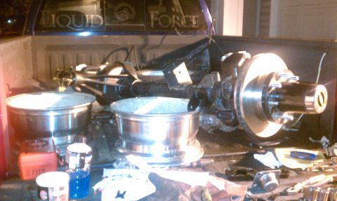 1990 Ford Bronco - Parts are loaded in the bed of a truck, ready for installation or transport.