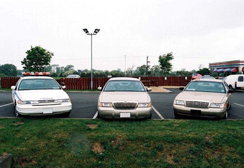 1999 Mercury Grand Marquis parked in a lot with two other sedans