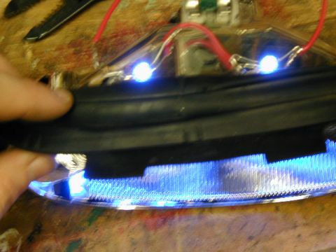 1998 Ford Taurus - A car part is being modified with blue LED lights and red wiring.