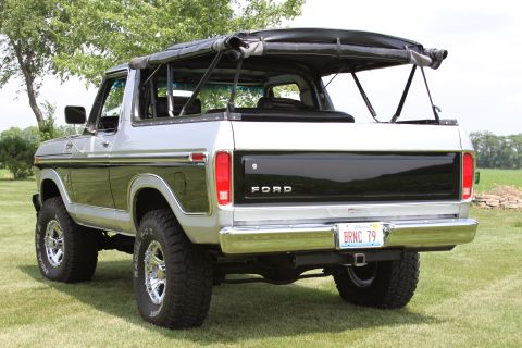 1979 Ford Bronco - This 1979 Ford Bronco is shown from the rear with its soft top up, parked on a grassy area.