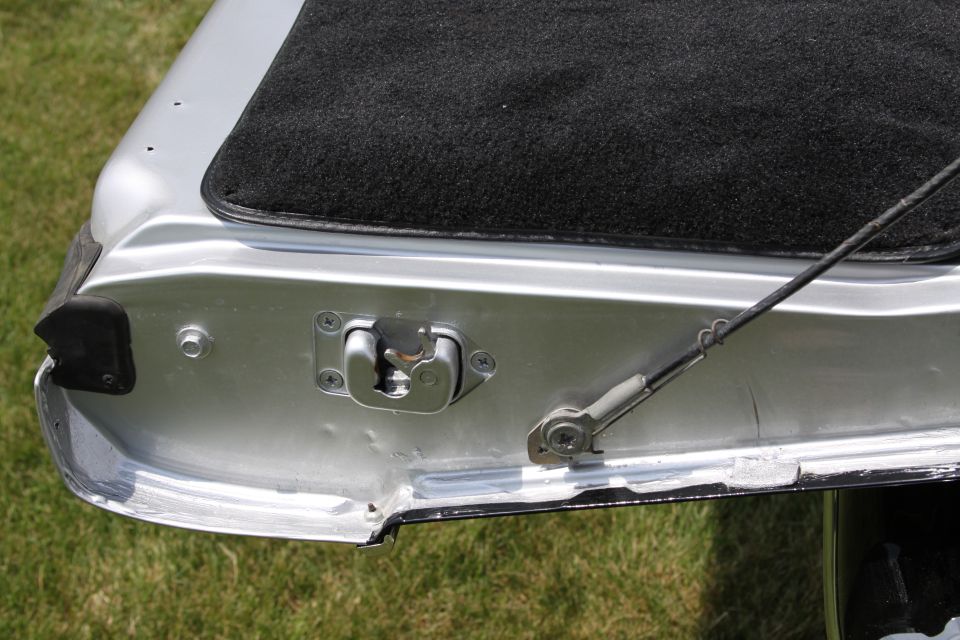 Close-up of tailgate latch mechanism and carpeted area