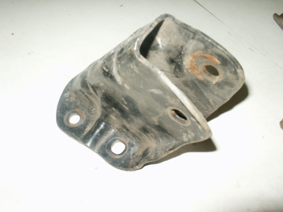 Black metal bracket with two mounting holes and rust spots, viewed from an angle