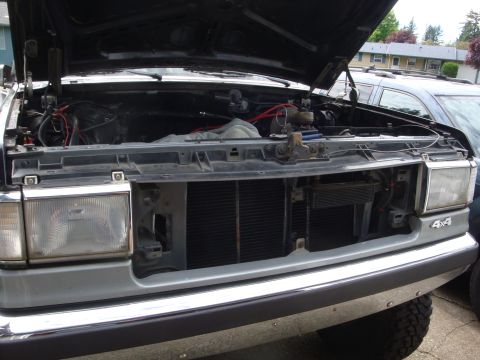 1989 Ford Bronco - Front view of a 1989 Ford Bronco with the hood open, revealing the engine compartment.