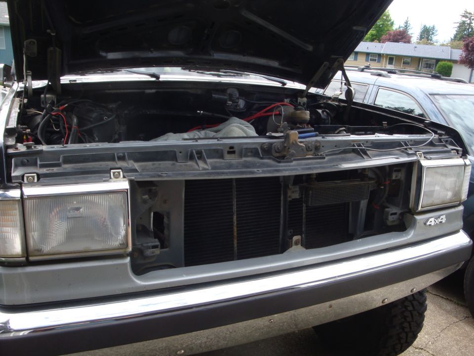 1989 Ford Bronco engine bay with hood open, showing grille and headlights