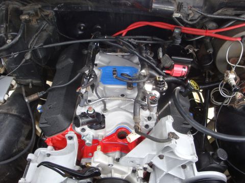 1989 Ford Bronco - The engine bay of a vehicle, with various components and wiring visible.