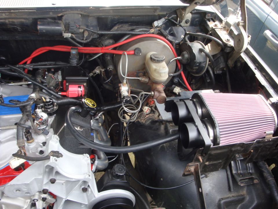 Engine bay with aftermarket air filter and red wiring