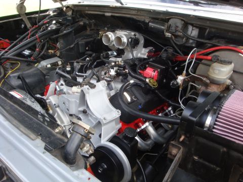 1989 Ford Bronco - Close-up view of a modified engine bay, custom performance parts and a prominent air filter.