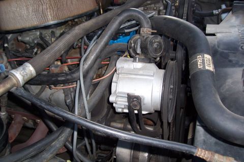 1988 Ford Bronco - Close-up of the engine bay of a 1988 Ford Bronco, showing various components and hoses.