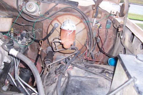 1988 Ford Bronco - Close-up view of the engine bay, focusing on the brake booster and master cylinder assembly. A watermark for Supermotors.net is present.