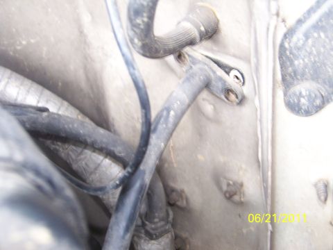 1989 Ford Bronco - Close-up view of hoses and a metal panel in an engine bay, with a date stamp visible.
