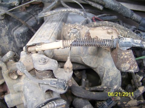 1989 Ford Bronco - Engine parts are covered in dirt and grime, obscuring any specific vehicle identification.