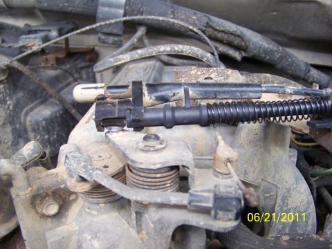 1989 Ford Bronco - Close-up view of an engine's throttle body assembly, showing sensors and associated wiring.