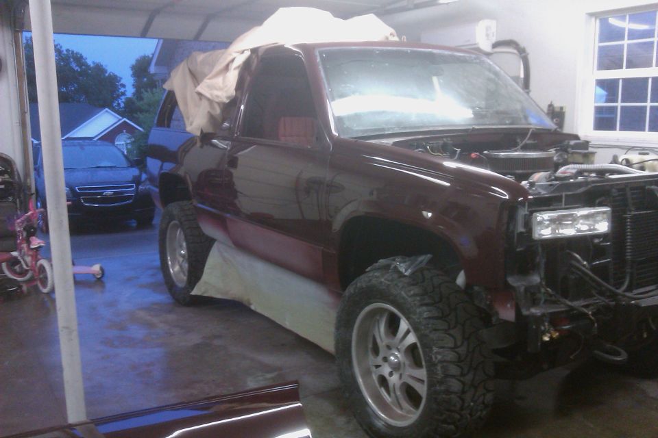 Maroon 1994 Chevrolet Blazer, front end disassembled, in garage