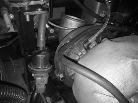 1995 Ford Probe - Engine bay detail showing a sensor and various hoses connected to mechanical parts.
