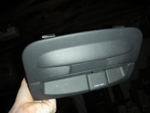 1998 Ford Crown Victoria - gray automotive center console section held by hand, featuring a padded armrest lid and a recess labeled POWER POINT.