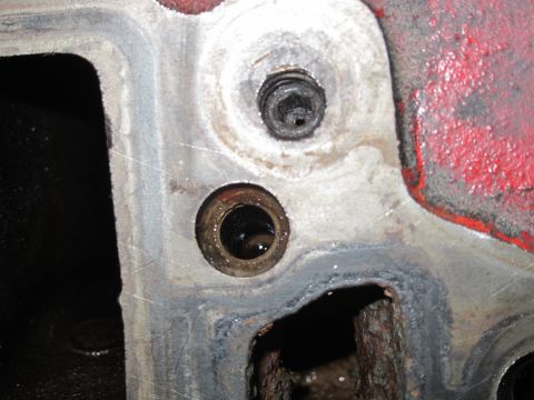 1940 Ford Coupe - Engine block detail showing a bolt and an opening to internal parts.