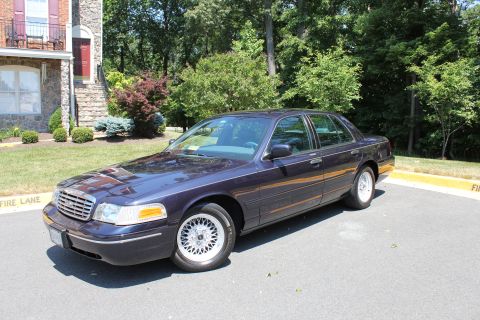 1999 Ford Crown Victoria - This 1998 Ford Crown Victoria is seen parked in front of a brick building.