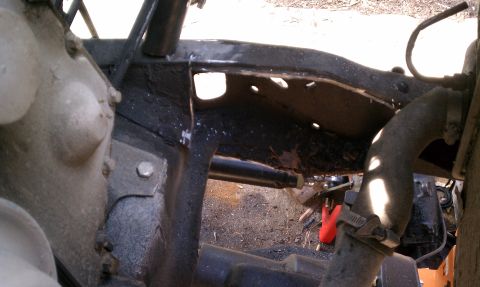 1990 Ford Bronco - Undercarriage view showing the frame structure and some hoses attached to the engine area.