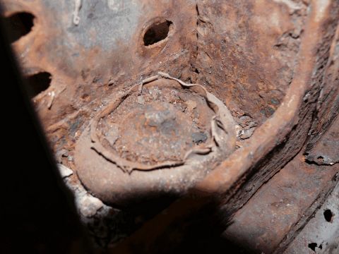 1976 Chevrolet Corvette - The vehicle's frame shows significant rust and deterioration, obscuring any specific details.