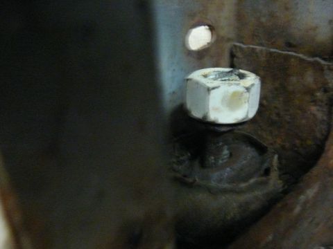 1976 Chevrolet Corvette - A close-up shows a bolt and nut, with some rust on the metal components.