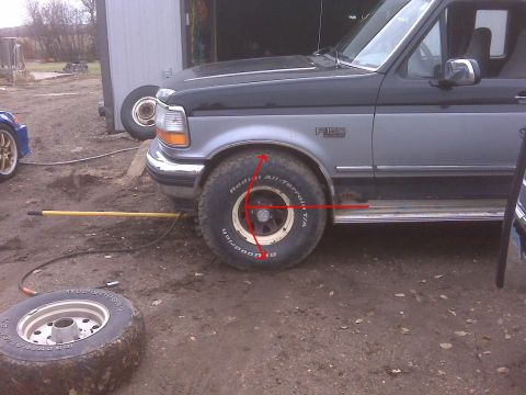 1994 Ford F-150 - A two-tone black and silver 1994 Ford F-150 pickup truck is parked outdoors next to another vehicle and a detached tire.