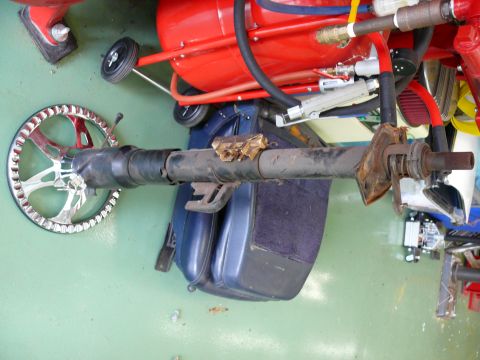 1976 Chevrolet Corvette - A disassembled steering column lies next to a red air compressor and blue car seat.