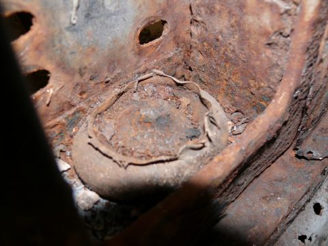 1976 Chevrolet Corvette - This image shows a severely corroded section of a vehicle's undercarriage, indicating significant rust damage.