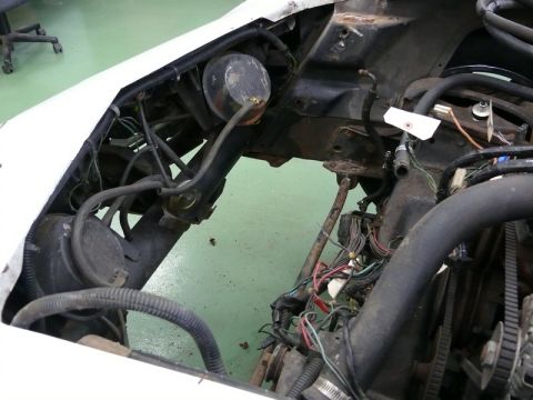 1976 Chevrolet Corvette - Close-up view of a car's engine bay, showing various mechanical parts and wiring.