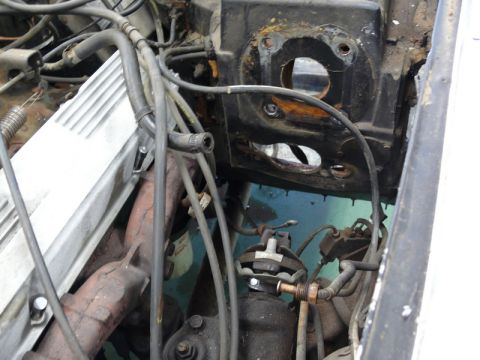 1976 Chevrolet Corvette - A view of various engine components, including hoses and wiring, within the engine bay.