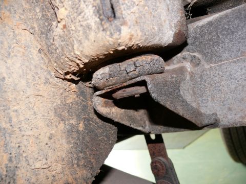 1976 Chevrolet Corvette - Close-up view of a deteriorated rubber body mount, showing significant cracking and wear.