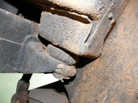 1976 Chevrolet Corvette - Close-up view of heavily corroded vehicle frame and suspension components.