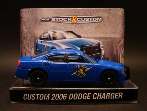 1993 Ford Taurus - Toy model of a 2006 Dodge Charger police car, displayed in its packaging.