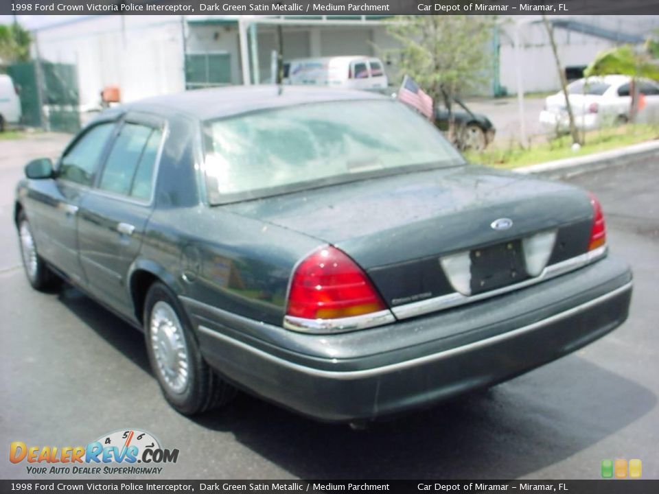 Dark green Ford Crown Victoria Police Interceptor parked outside