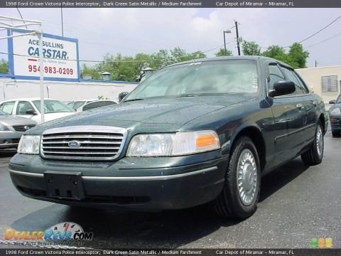 1998 Ford Crown Victoria - This dark green 1998 Ford Crown Victoria Police Interceptor is shown from the front three-quarter angle.
