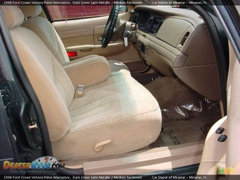 1998 Ford Crown Victoria - The interior of a 1998 Ford Crown Victoria Police Interceptor features tan cloth seats and a beige dashboard.