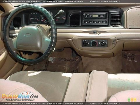 1998 Ford Crown Victoria - The interior of a 1998 Ford Crown Victoria Police Interceptor is shown, the dashboard and front seats.