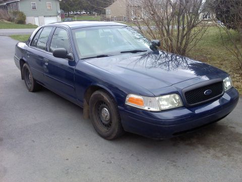 2002 Ford Crown Victoria - Front 3/4 view of a blue 2002 Ford Crown Victoria sedan.