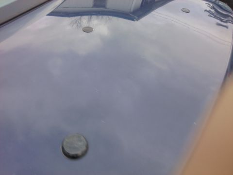 2002 Ford Crown Victoria - The hood of a blue vehicle shows three circular indentations, with a Supermotors.net watermark visible in the lower right corner.