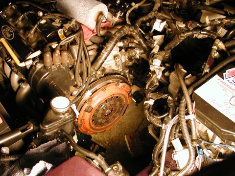 1996 Ford Probe - Close-up view of a vehicle's engine bay, focusing on the clutch and surrounding mechanical components.