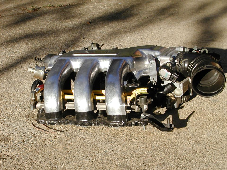 Engine intake manifold with four runners and throttle body