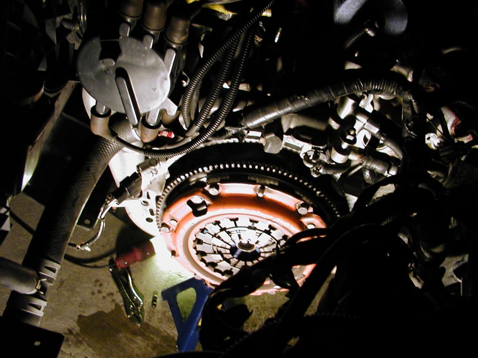 Close-up of an engine clutch assembly with visible flywheel and pressure plate