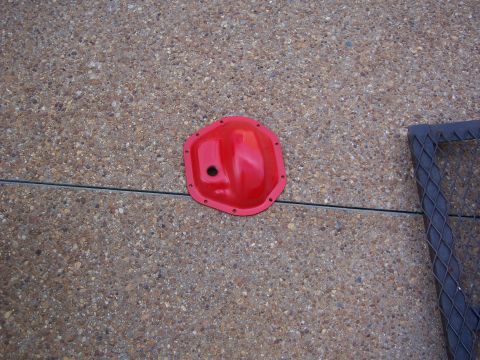 1992 Ford Bronco - A red differential cover is shown on a textured concrete surface.