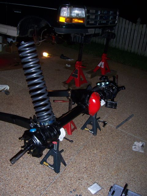 1992 Ford Bronco - Front axle and suspension components of a 1992 Ford Bronco are disassembled and supported by jack stands.