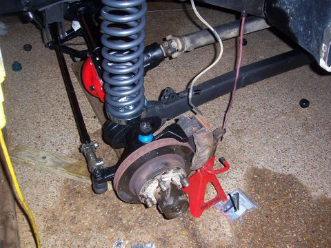 1992 Ford Bronco - Close-up view of vehicle suspension and brake parts during maintenance or repair.