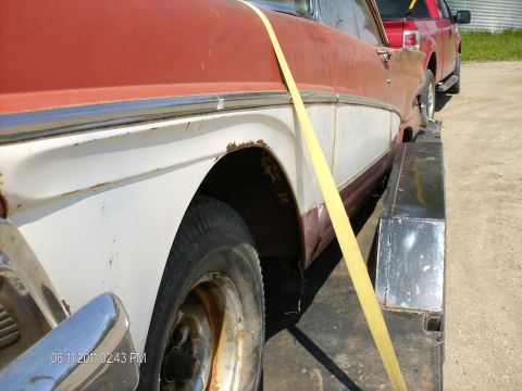 1958 Ford Fairlane - A 1958 Ford Fairlane, identified by its distinctive side trim and body style, is secured on a trailer for transport.