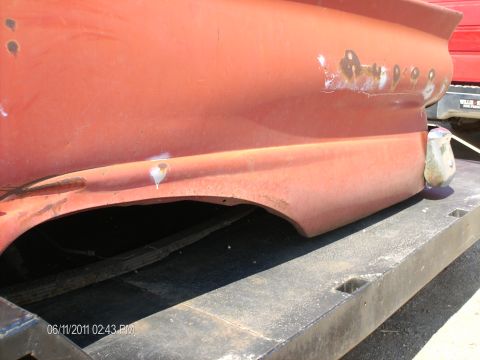 1958 Ford Fairlane - The rear quarter panel and fender show signs of rust and damage, indicating it's a project vehicle.