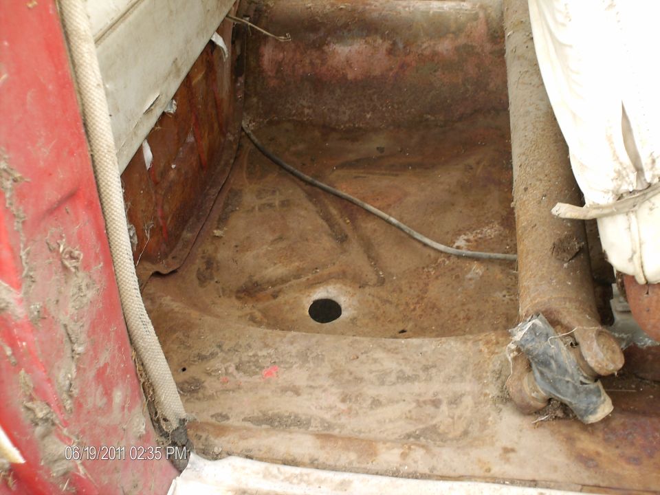 Interior floor pan with drain hole and surface rust