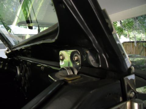 1978 Ford Bronco - Close-up of the windshield hinge area inside a 1978 Ford Bronco. Supermotors.net logo is visible.